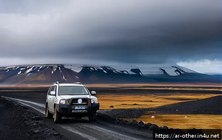 아이슬란드 자동차 렌트 시 주의사항 - A rugged 4x4 SUV parked on a gravel volcanic road in Iceland during a cloudy day, surrounded by blac...